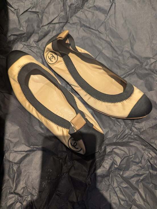 CHANEL Shoes - Tan and black Chanel ballet flats.